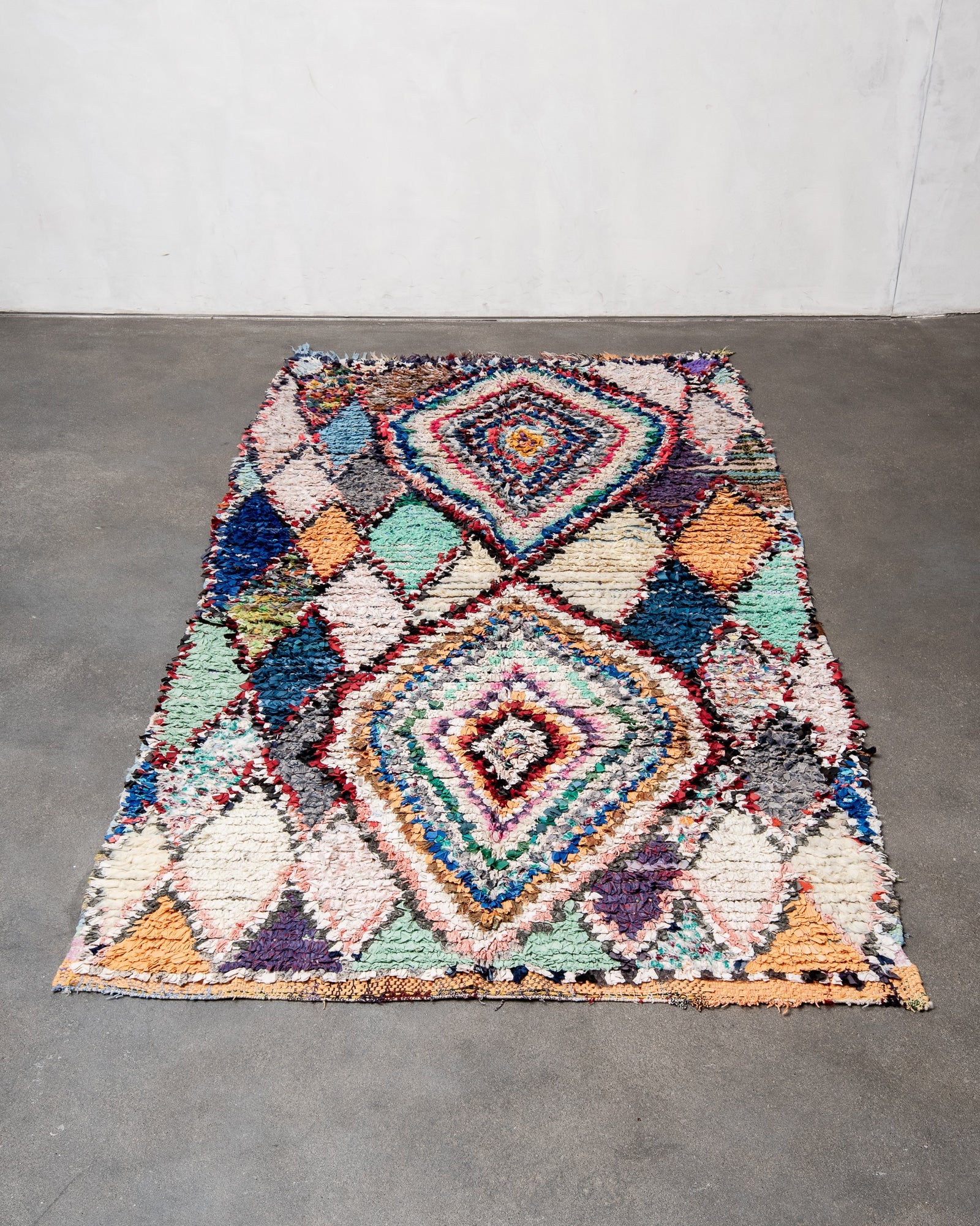 Modern designer vintage handcrafted cotton Berber rug from Morocco. Boucherouite with beautiful colors and patterns.